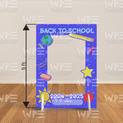 Blue back to school photo frame backdrop with school supplies and 2024-2025 text standing on wooden floor