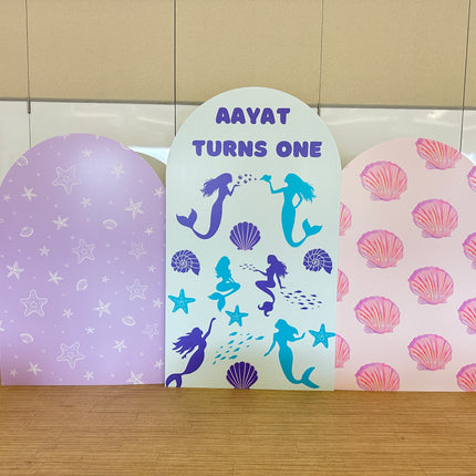 Custom foam backdrop printing featuring purple starfish, mermaid design, and pink seashell patterns for birthday decoration