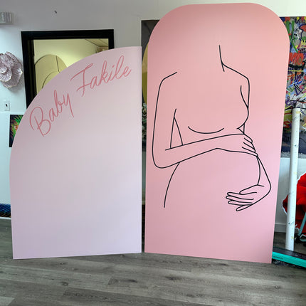 Custom foam backdrop printing featuring a pink maternity outline and Baby Fakile text by WPEProduction