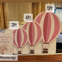 Custom foam cutouts of hot air balloons in 3ft 4ft and 5ft sizes displayed at birthday welcome sign