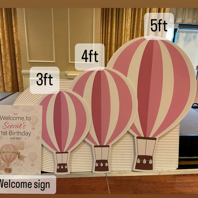 Custom foam cutouts of hot air balloons in 3ft 4ft and 5ft sizes displayed at birthday welcome sign