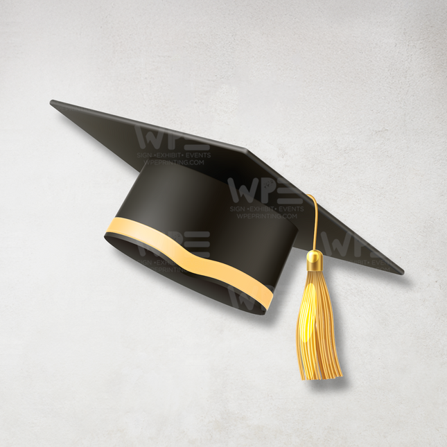 Black custom graduation cap cutout with gold tassel and trim floating against a white background