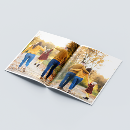 Custom printed booklets showcasing a family enjoying a walk in a scenic park with autumn leaves