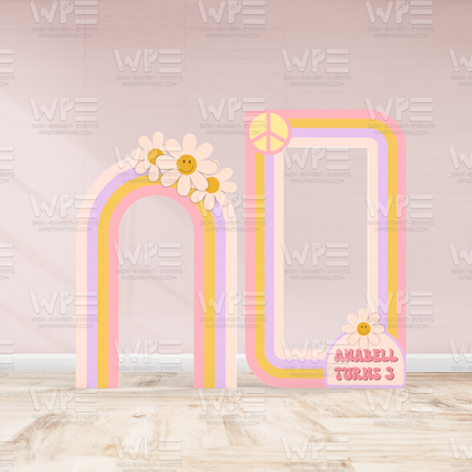 Groovy birthday backdrop decorations with retro rainbow arches, daisies, and peace sign for kids party