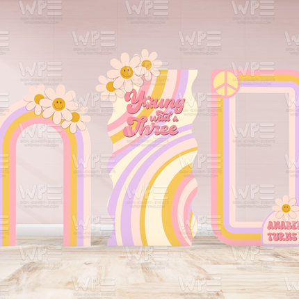 Groovy birthday backdrop decorations with retro pastel rainbows, daisies, and peace sign for a third birthday party