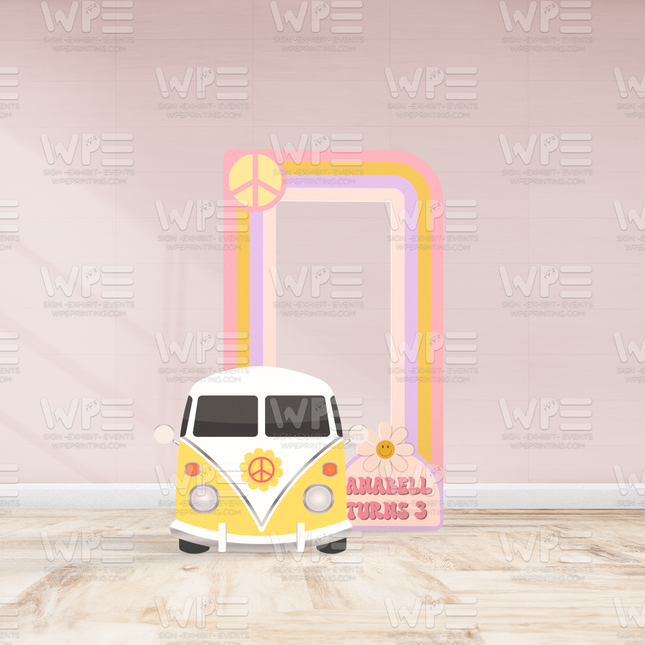 Yellow and white vintage van with peace sign and groovy birthday backdrop decorations featuring pink and orange stripes on a light pink wall