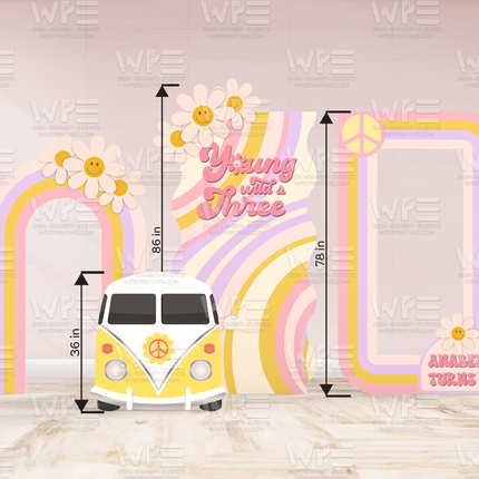 Colorful groovy birthday backdrop decorations with retro van, rainbow arches, and peace sign frame for party