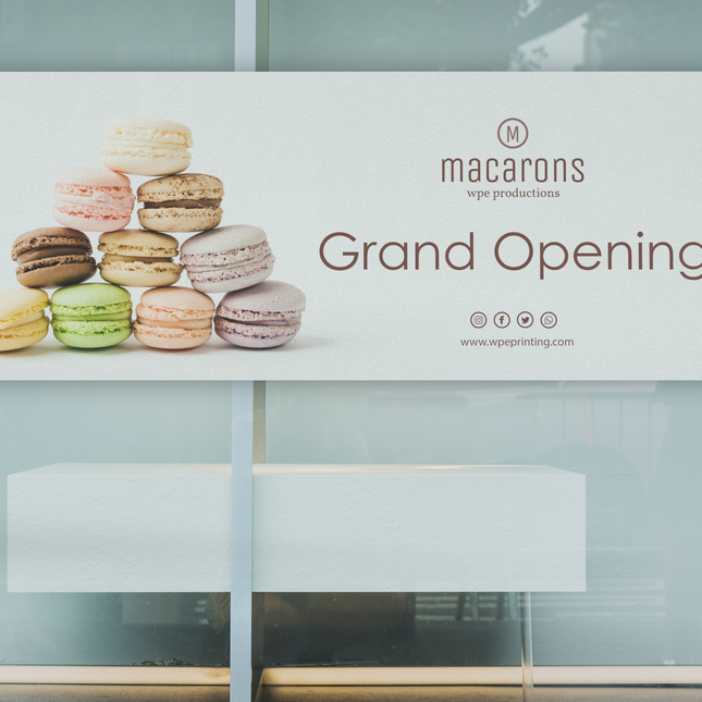 WPEProduction custom printed vinyl banners showcasing a grand opening design with colorful macarons image