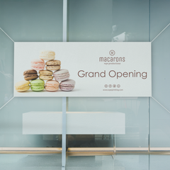 Custom printed vinyl banners featuring colorful macarons for a Grand Opening event