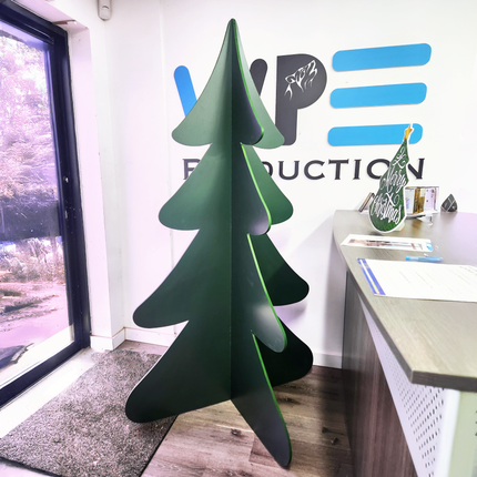 Personalized 3D Christmas decor featuring a green cutout tree displayed in an office settingPine Tree Prop