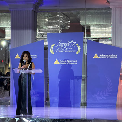 Personalized stage backdrop panels featuring event branding at the Jewels of Asia Gala