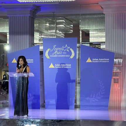 Elegant personalized stage backdrop panels for events, featuring Asian American Chamber of Commerce branding