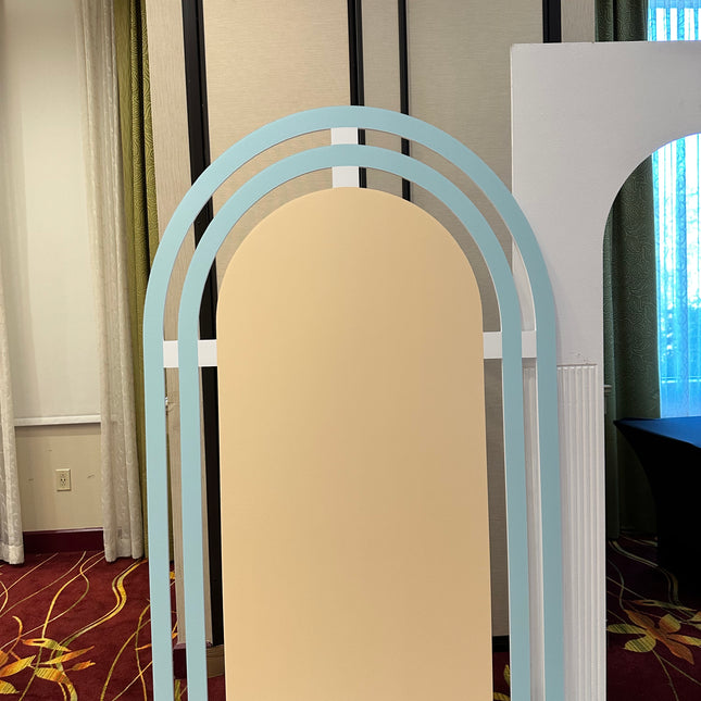 Light blue and beige rainbow panel foam board backdrop with arched design for events