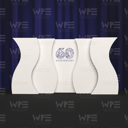 Curved stage backdrop set featuring an elegant 60th anniversary design on a dark stage