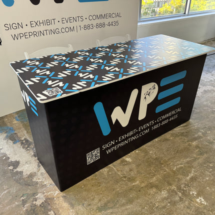 Custom branded table featuring WPE Production logo and design for events and exhibitions
