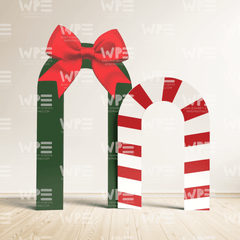 Holiday event entrance props featuring a green arch with a red bow and a striped candy cane design